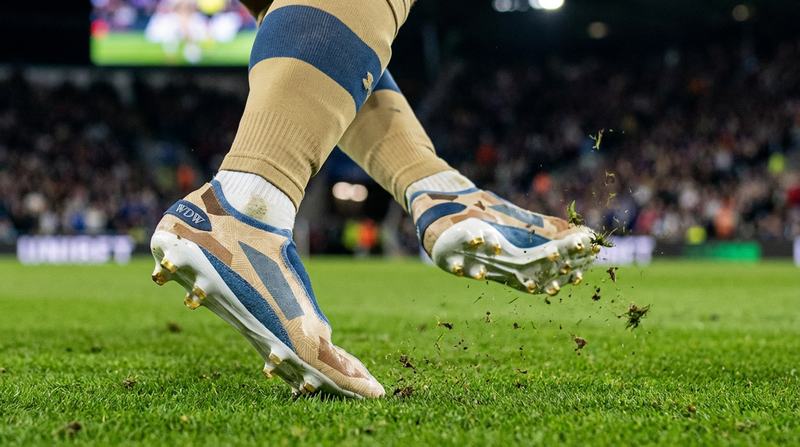 Layered-fabric cleats in play on the pitch