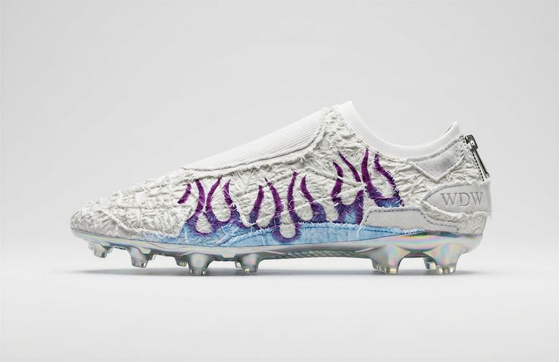 Soccer cleat with purple stitched flames