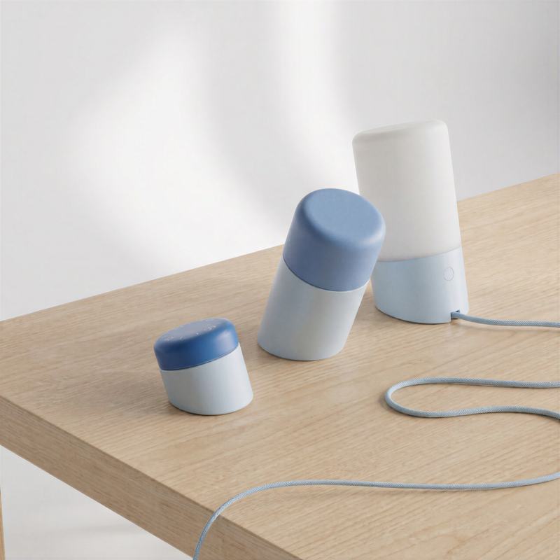 Lamps on a wooden table with a blue cable